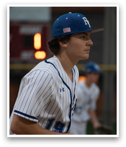 A baseball player wearing a blue and white uniform. Description generated by AI