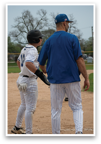 A man wearing a blue and white baseball uniform. Description generated by AI