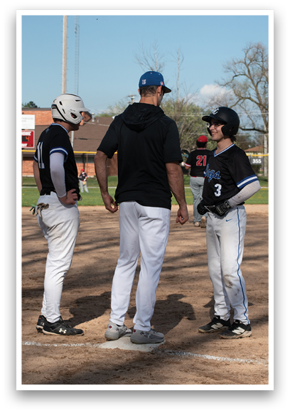 A group of people standing on a baseball field. Description generated by AI
