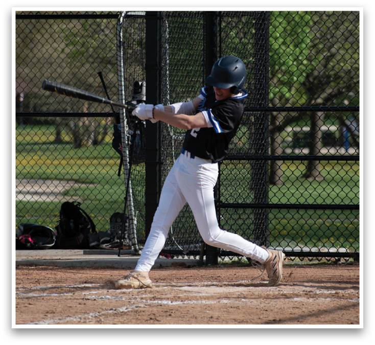 A baseball player is swinging a bat at a ball. Description generated by AI