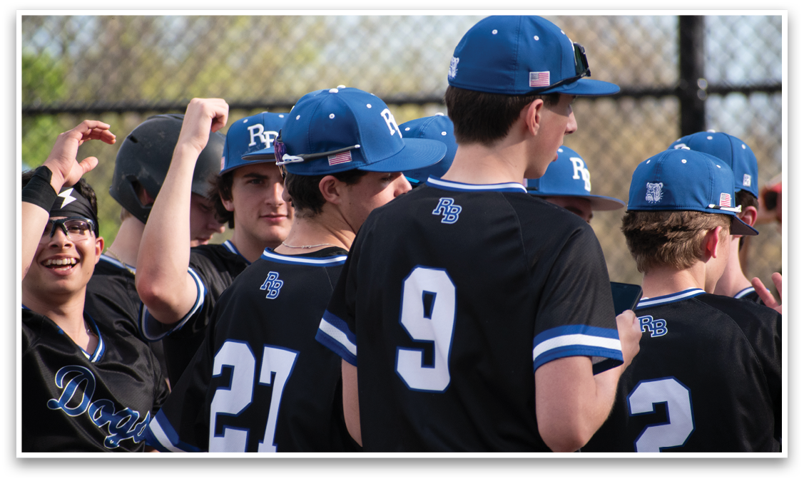 A group of young men wearing blue and black baseball caps. Description generated by AI
