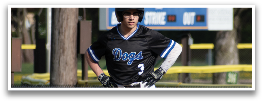 A baseball player wearing a black and blue shirt and white pants. Description generated by AI