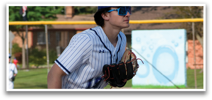 A baseball player with a blue and white uniform and a baseball glove. Description generated by AI