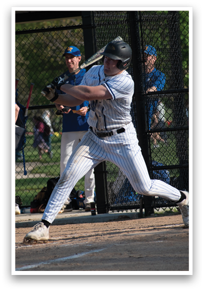 A baseball player in a blue and white uniform is swinging a bat. Description generated by AI