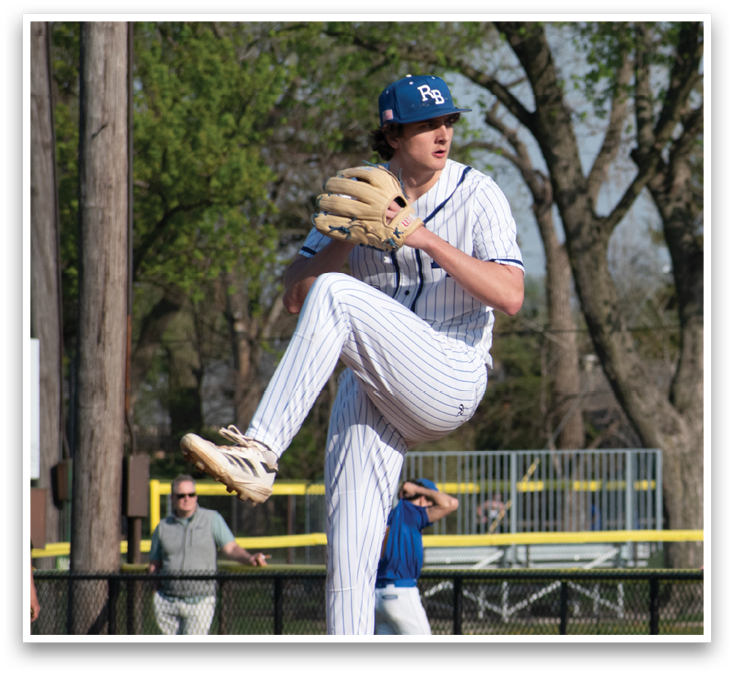 A baseball player in a white uniform is pitching a ball. Description generated by AI
