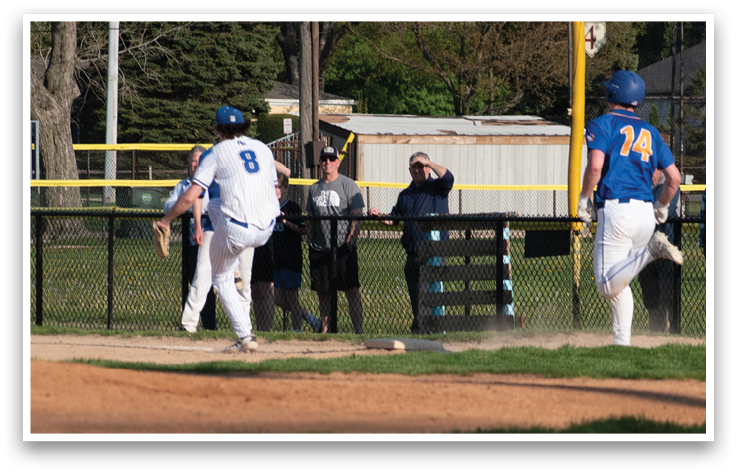 A baseball game is taking place in a field with a man running to a base. Description generated by AI
