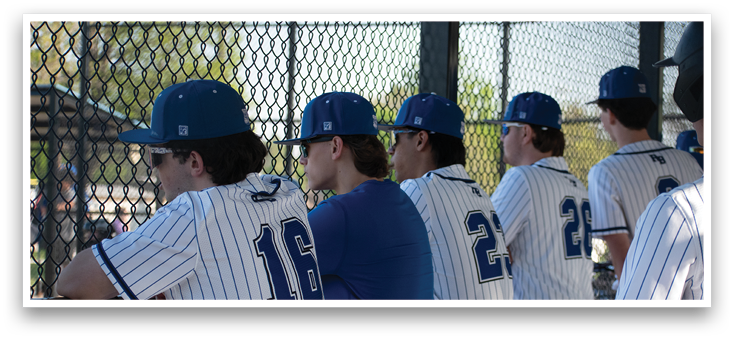 Baseball players wearing blue and white uniforms. Description generated by AI
