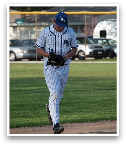 A baseball player wearing a blue hat and white uniform. Description generated by AI