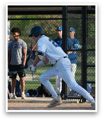 A baseball player in a white uniform is running to first base. Description generated by AI