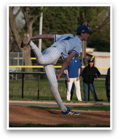 A baseball player in a white and blue uniform is in the middle of a pitch. Description generated by AI