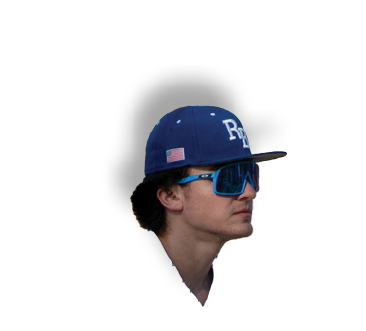 A man wearing a blue hat is looking at the camera. Description generated by AI