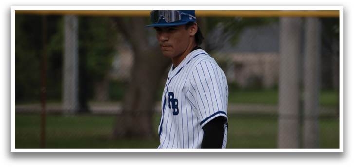 A baseball player wearing a blue and white uniform. Description generated by AI