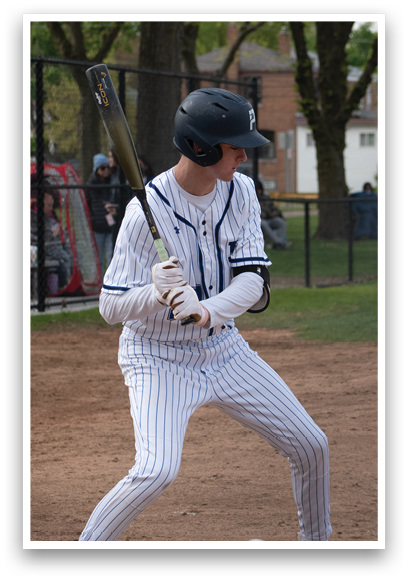 A baseball player in a blue and white uniform is swinging a bat. Description generated by AI