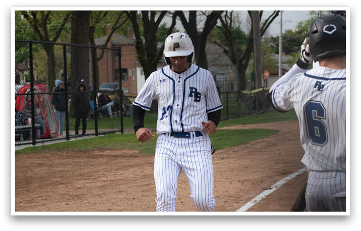A baseball player wearing a blue and white uniform is walking across the field. Description generated by AI
