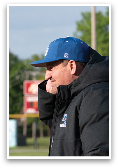 A man wearing a blue and white hat and a black jacket. Description generated by AI