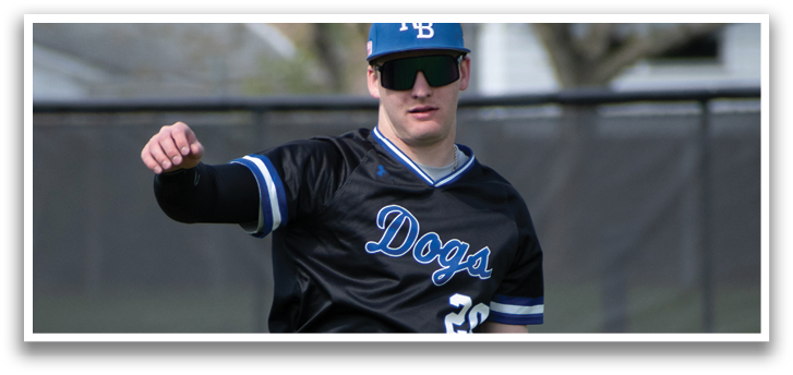 A baseball player wearing a black jersey with the number 27 on it. Description generated by AI