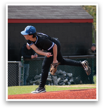 A boy in a blue hat and black shirt is throwing a baseball. Description generated by AI