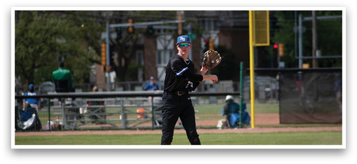 A baseball player wearing a black shirt and black pants is standing on a baseball field. Description generated by AI