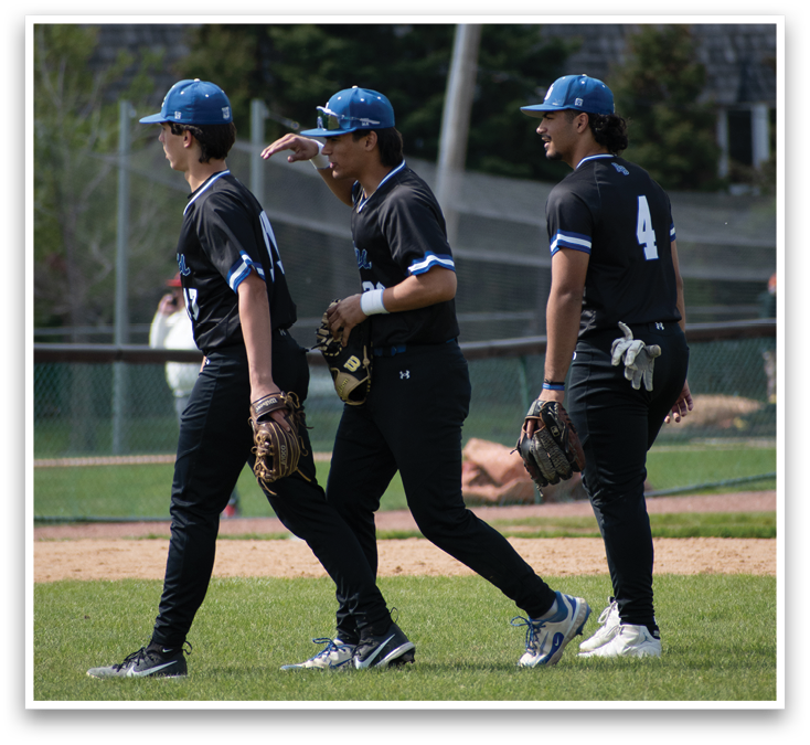 Three baseball players walking on a field. Description generated by AI