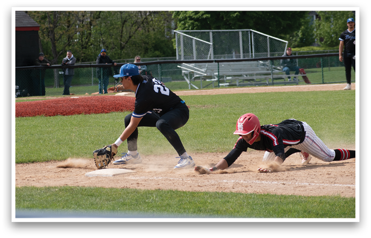 A baseball player sliding into a base. Description generated by AI