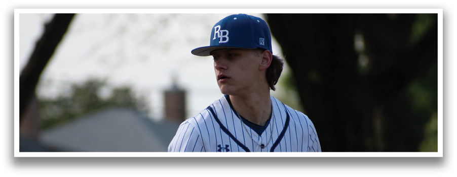 A baseball player wearing a blue and white uniform. Description generated by AI