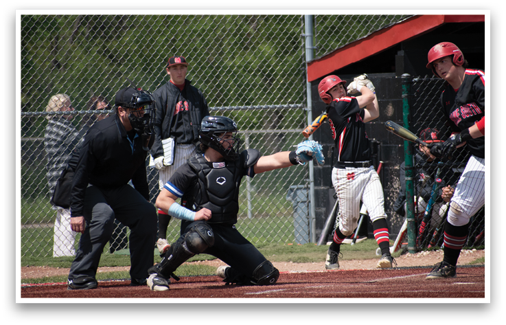 A baseball player is holding a bat and getting ready to swing. Description generated by AI