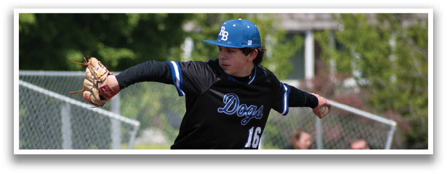 A baseball player in a black and blue uniform is pitching a ball. Description generated by AI