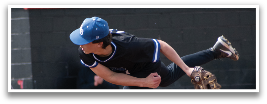 A baseball player in a black shirt and blue hat is pitching a ball. Description generated by AI