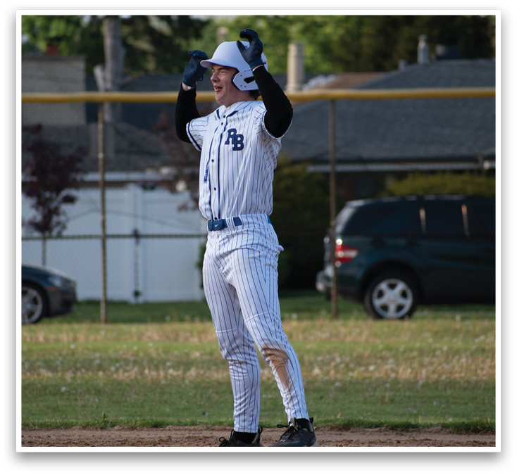 A baseball player wearing a blue and white uniform is celebrating. Description generated by AI