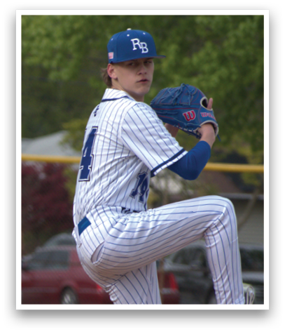 A baseball player in a blue and white uniform is pitching a ball. Description generated by AI