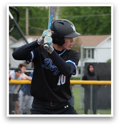 A baseball player in a black jersey and helmet is swinging a bat. Description generated by AI