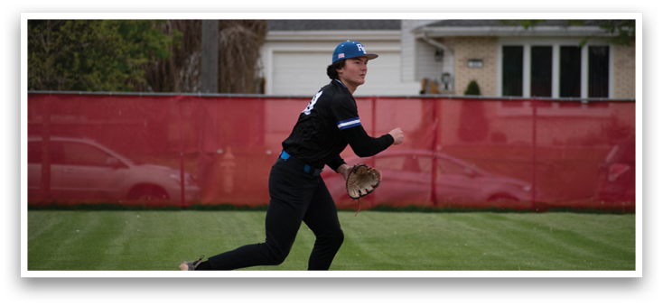 A person wearing a black shirt and blue shorts is running on a field. Description generated by AI