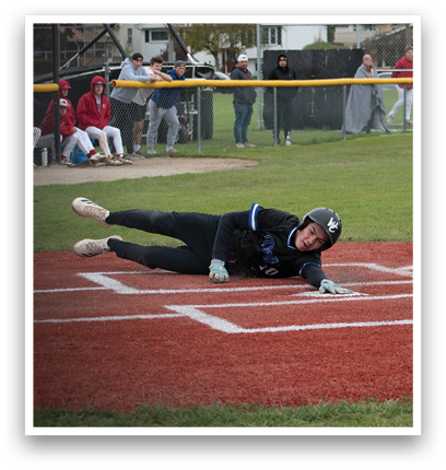 A baseball player slides into home plate. Description generated by AI