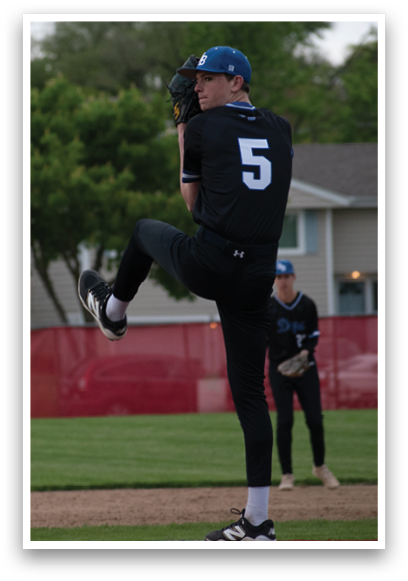 A baseball player in a black shirt and blue hat is pitching a ball. Description generated by AI
