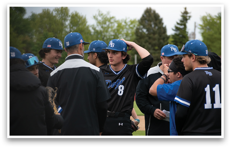 A group of people wearing blue and black baseball caps and jerseys. Description generated by AI