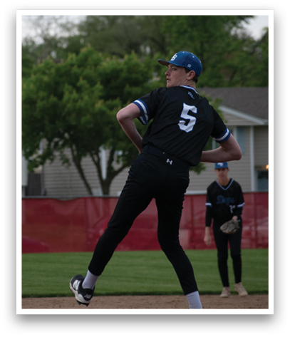 A baseball player wearing a blue hat and black shirt. Description generated by AI