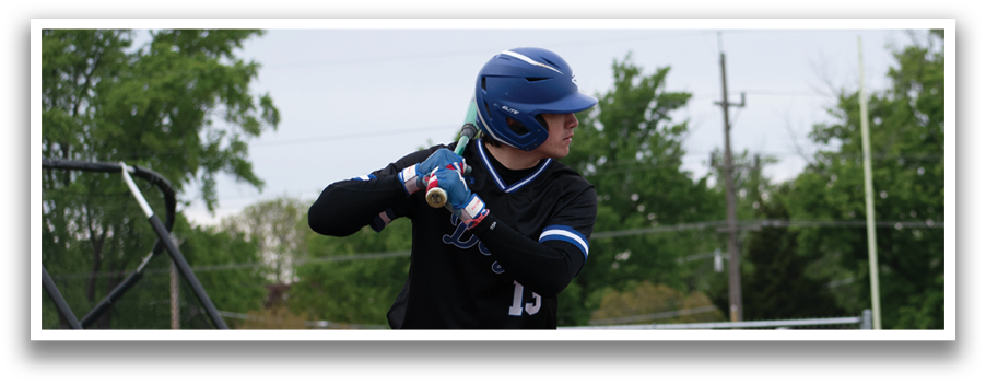 A baseball player in a blue helmet and black shirt is swinging a bat. Description generated by AI