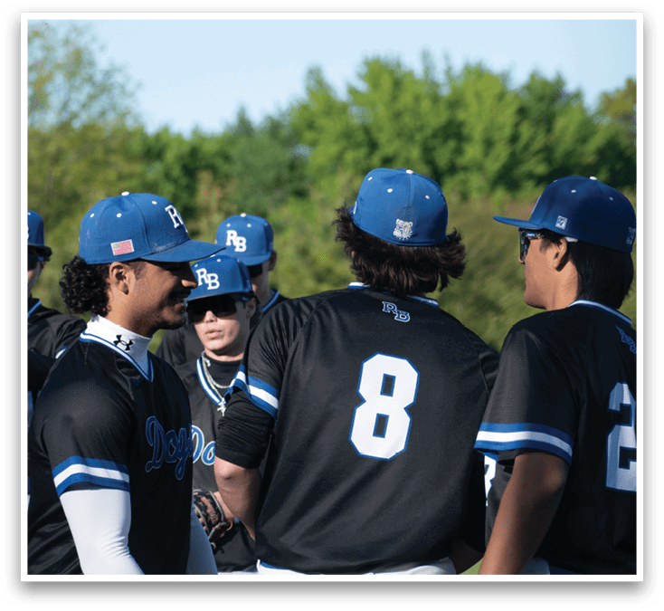 A group of baseball players wearing blue and black uniforms. Description generated by AI