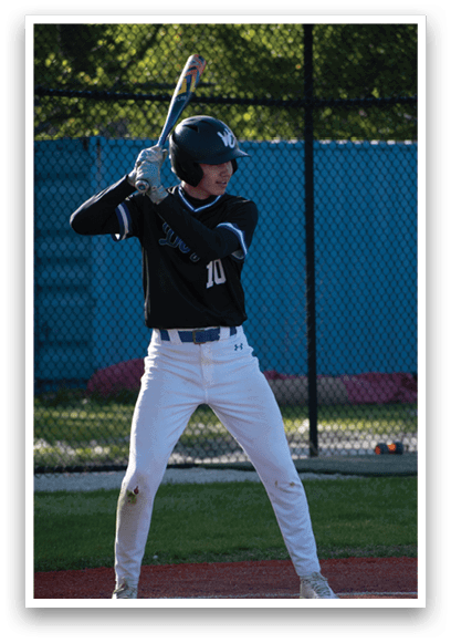 A baseball player holding a bat. Description generated by AI
