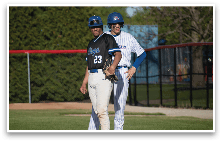 Two baseball players on a field. Description generated by AI