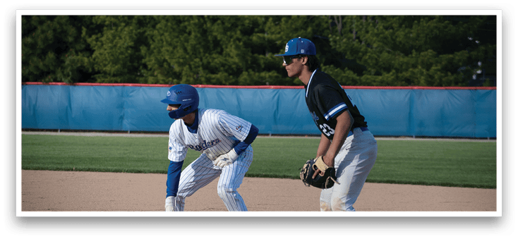 Two baseball players on a field. Description generated by AI
