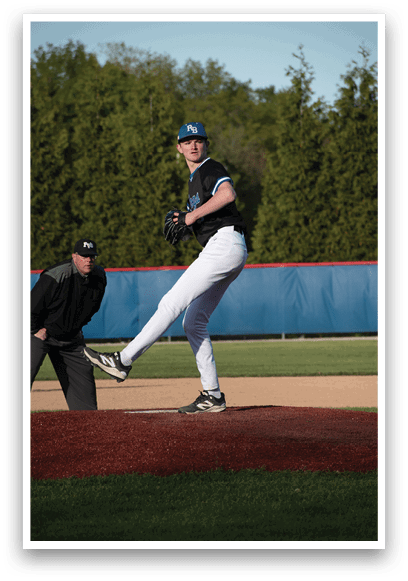 A baseball player in a black shirt and white pants is pitching a ball. Description generated by AI