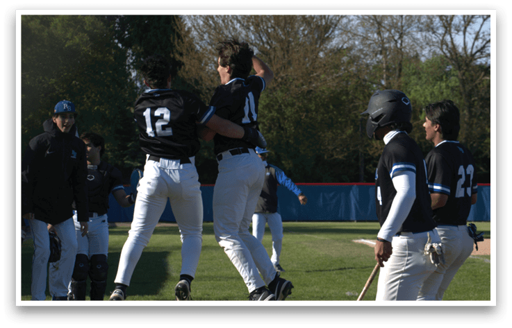 A group of baseball players celebrating a win. Description generated by AI