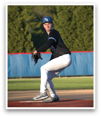 A baseball player in a black shirt and white pants is on the mound. Description generated by AI