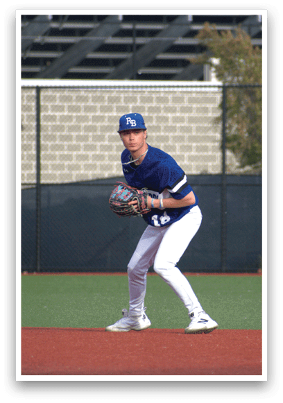 A baseball player in a blue and white uniform is standing on the field. Description generated by AI