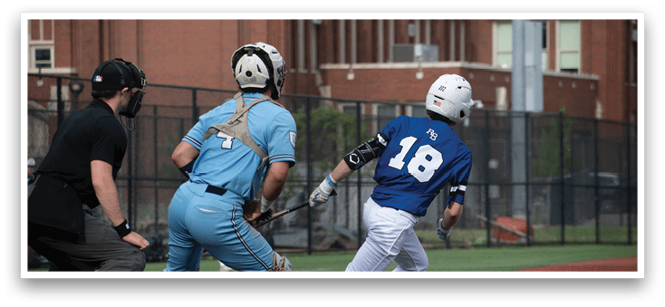 A baseball player in a blue shirt and white pants is running to first base. Description generated by AI