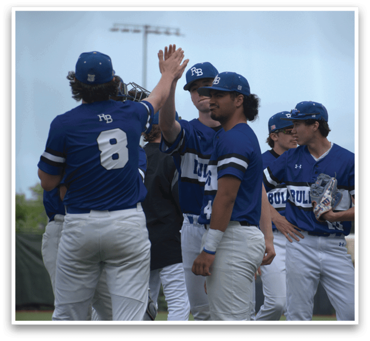 A group of baseball players wearing blue and white uniforms. Description generated by AI