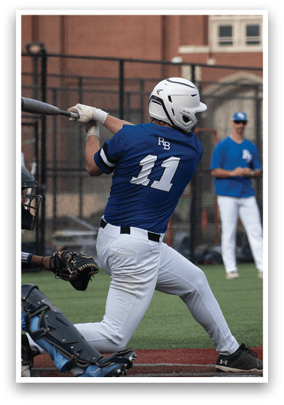 A baseball player in a blue shirt and white pants is swinging a bat. Description generated by AI