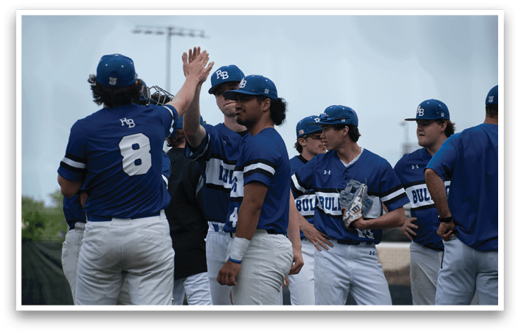 A group of baseball players wearing blue and white uniforms. Description generated by AI