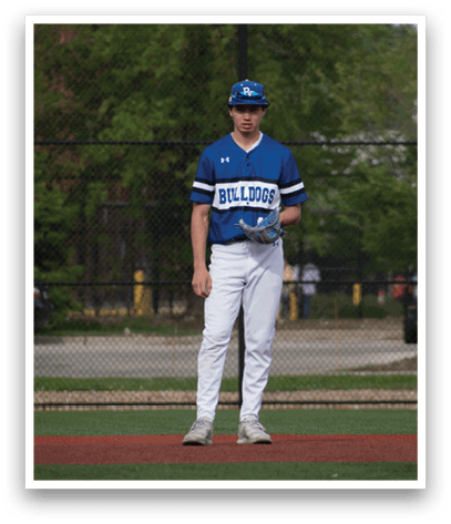 A baseball player in a blue and white uniform stands on the field. Description generated by AI